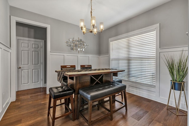 dining area with dark hardwood / wood-style flooring and a chandelier