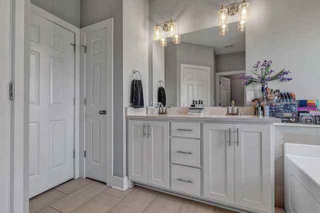 bathroom with vanity and a tub