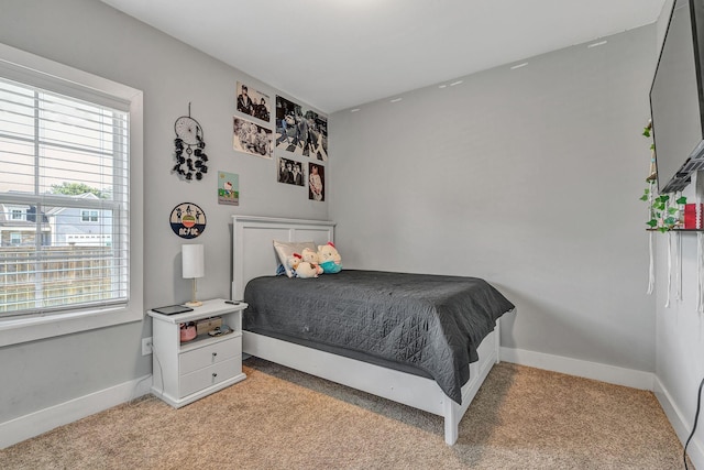 bedroom featuring light colored carpet