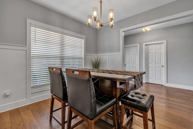 dining space with an inviting chandelier and wood-type flooring