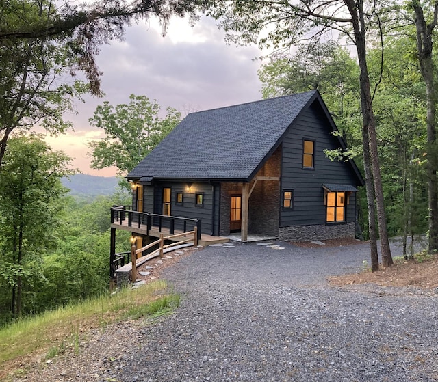 239 Deer Ridge Trl, Ocoee, TN 37361 - chalet / cabin with driveway, a shingled roof, and stone siding