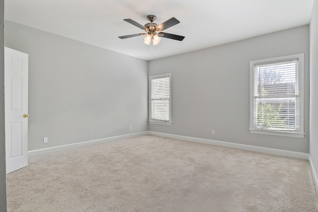 empty room with light colored carpet and ceiling fan