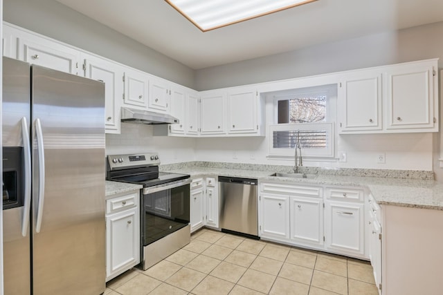 kitchen with light tile patterned flooring, appliances with stainless steel finishes, tasteful backsplash, sink, and white cabinets