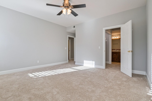 unfurnished bedroom featuring light colored carpet and ceiling fan