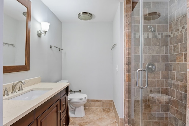 bathroom with vanity, toilet, an enclosed shower, and tile patterned flooring