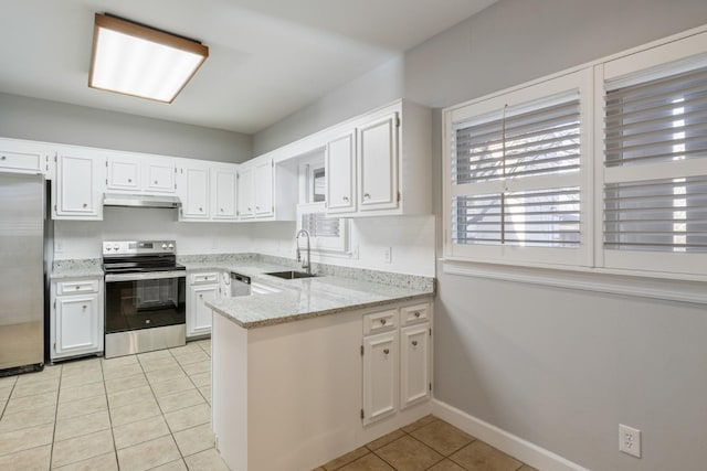 kitchen with light stone counters, appliances with stainless steel finishes, sink, and white cabinets