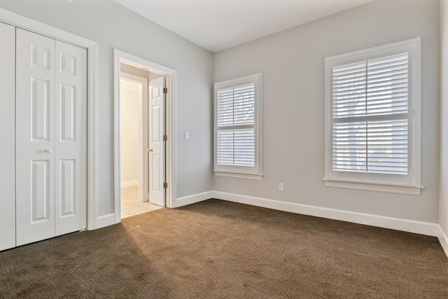 unfurnished bedroom with carpet floors and a closet