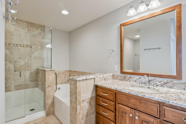 bathroom featuring independent shower and bath, vanity, tile patterned flooring, and tile walls