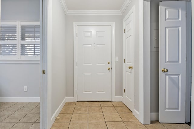 entrance foyer with light tile patterned floors and crown molding