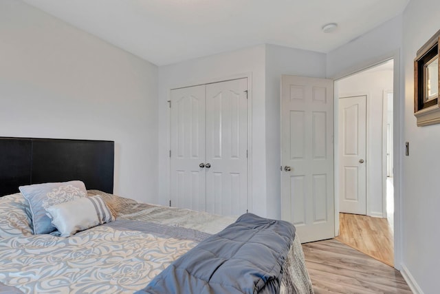 bedroom featuring a closet and light wood-type flooring