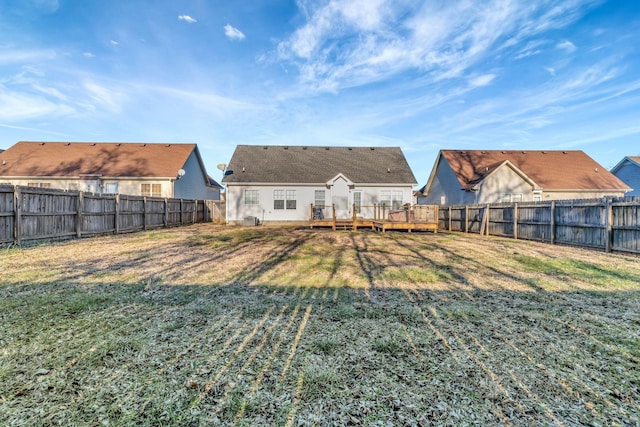 rear view of house with a lawn and a deck