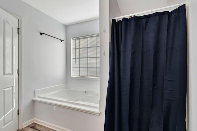 bathroom with a tub to relax in