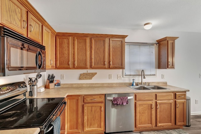 kitchen with hardwood / wood-style flooring, dishwasher, sink, and electric stove