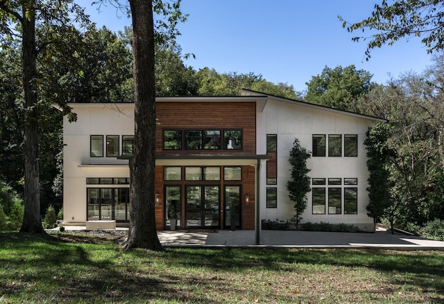 back of house with a patio, a lawn, and french doors