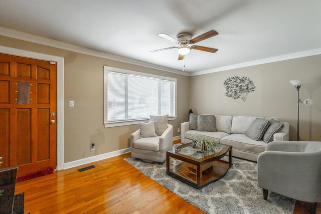 living room featuring ceiling fan, ornamental molding, and hardwood / wood-style floors