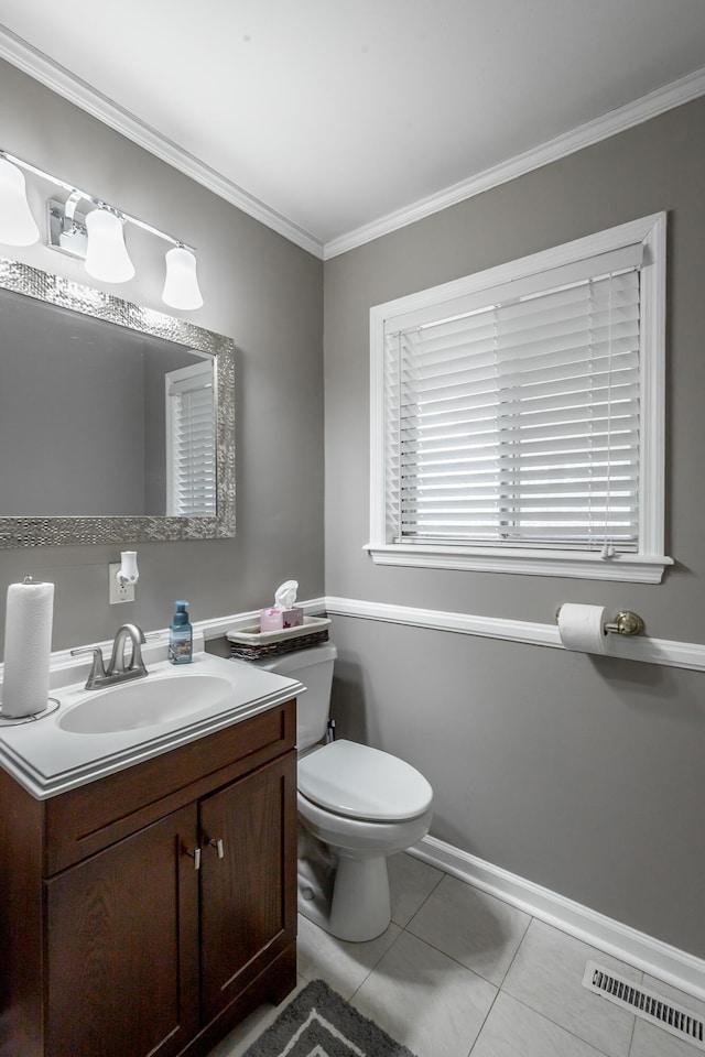 bathroom with vanity, ornamental molding, tile patterned floors, and toilet