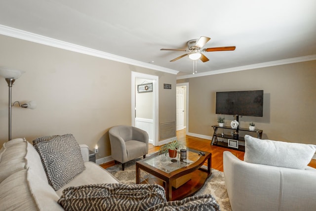 living room with ornamental molding, hardwood / wood-style floors, and ceiling fan