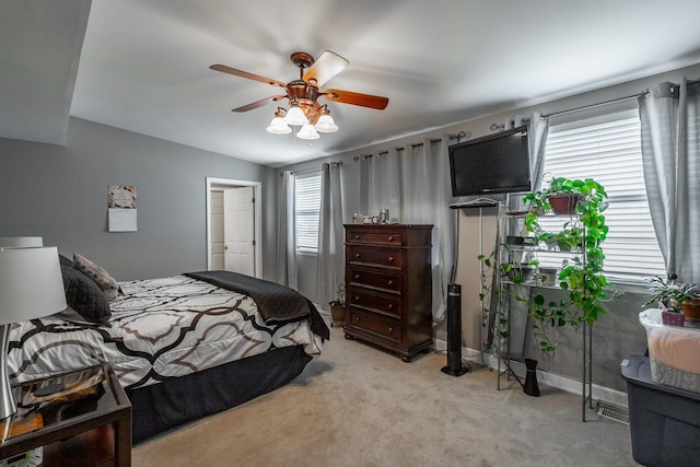 carpeted bedroom with vaulted ceiling and ceiling fan