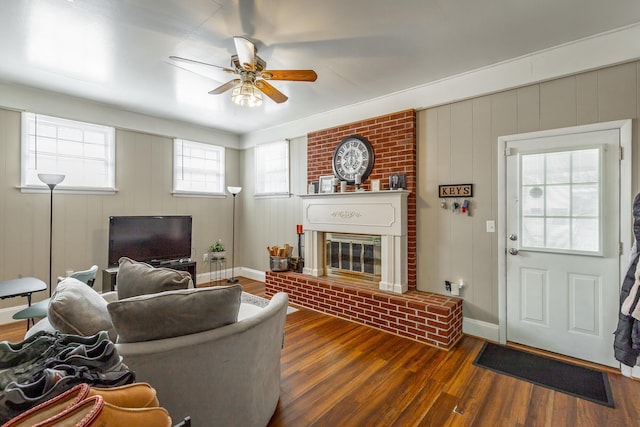 living room with ceiling fan, a fireplace, and dark hardwood / wood-style flooring