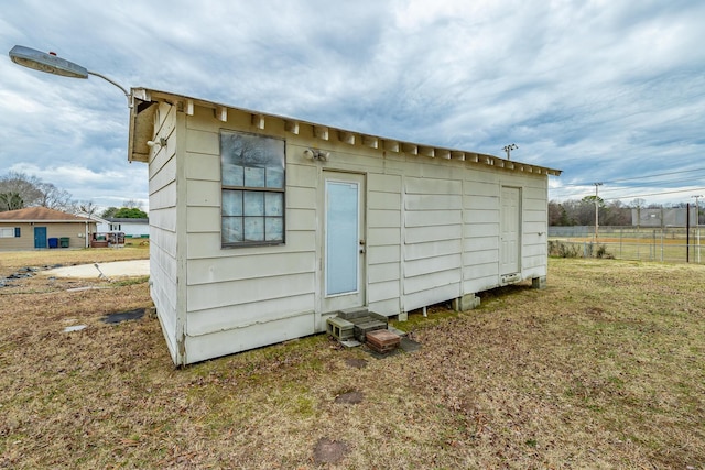 view of outbuilding with a lawn