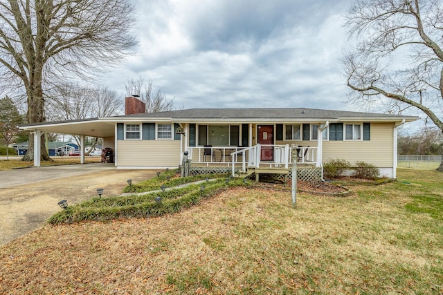 single story home featuring a carport, a front yard, and covered porch