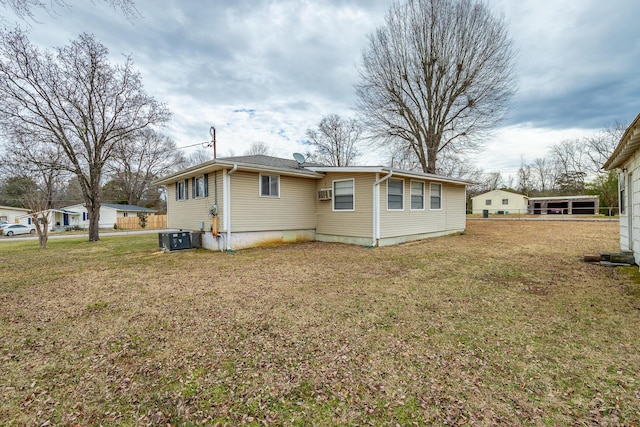 back of property with cooling unit and a lawn