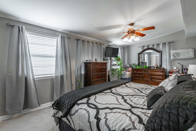 bedroom with light carpet and ceiling fan