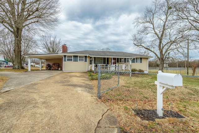 single story home with a carport, covered porch, and a front lawn