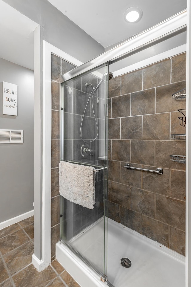 bathroom with a shower with shower door