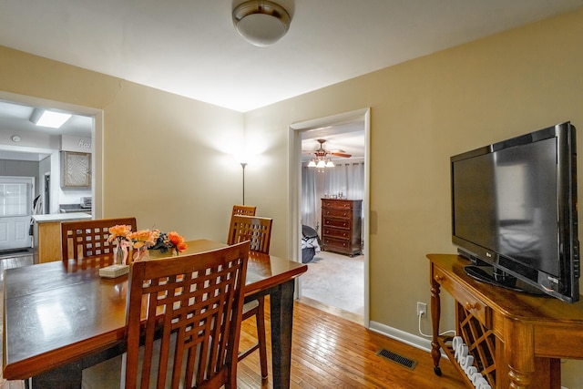 dining room with hardwood / wood-style floors and ceiling fan