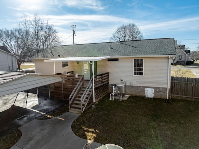 rear view of house featuring a carport