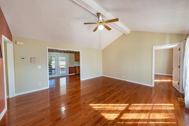 unfurnished living room with lofted ceiling with beams, wood-type flooring, ceiling fan, and french doors