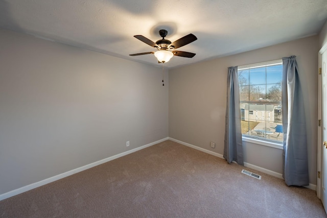 carpeted empty room featuring ceiling fan