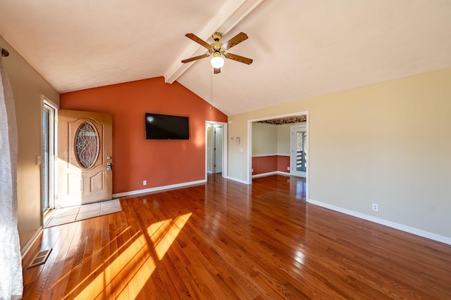 unfurnished living room with hardwood / wood-style flooring, vaulted ceiling with beams, and ceiling fan