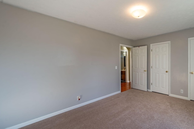 unfurnished bedroom featuring light carpet