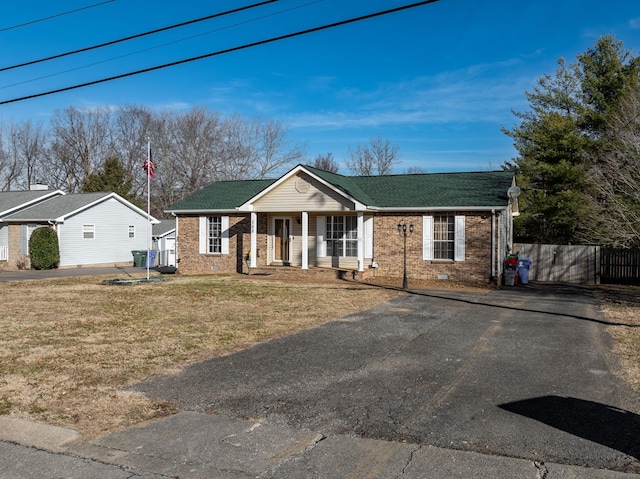 single story home with covered porch and a front yard