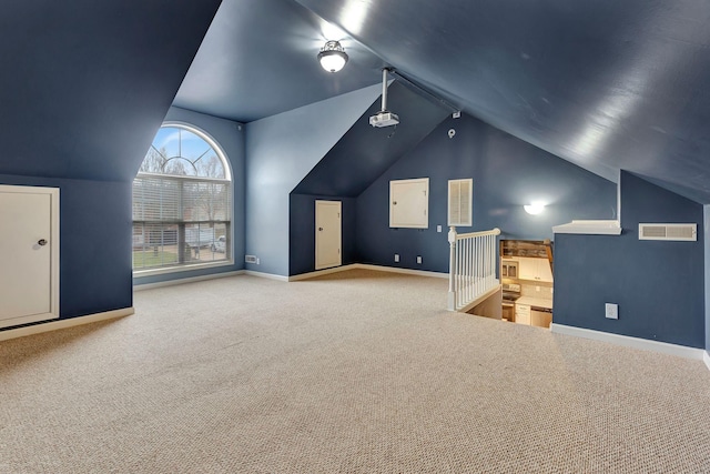 bonus room featuring vaulted ceiling and carpet floors