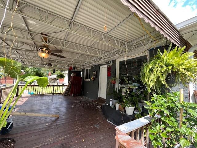 wooden deck featuring ceiling fan