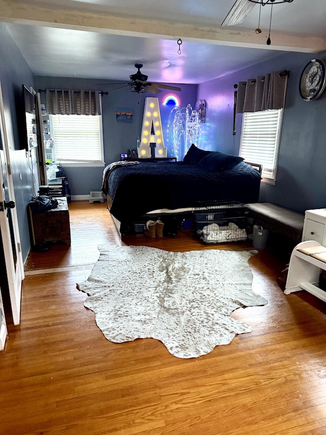 bedroom with ceiling fan and wood-type flooring