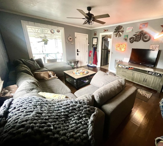 living room with wood-type flooring, ornamental molding, and ceiling fan