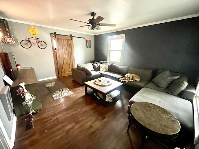 living room with crown molding, dark hardwood / wood-style floors, a barn door, and ceiling fan