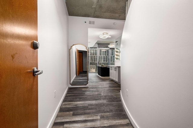 hallway with dark wood-type flooring