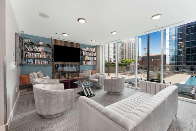 living room featuring carpet flooring and a wall of windows