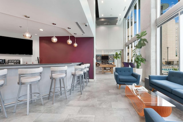 interior space featuring decorative light fixtures and a towering ceiling