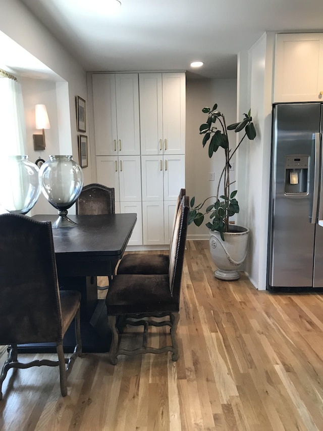 dining space with light hardwood / wood-style floors