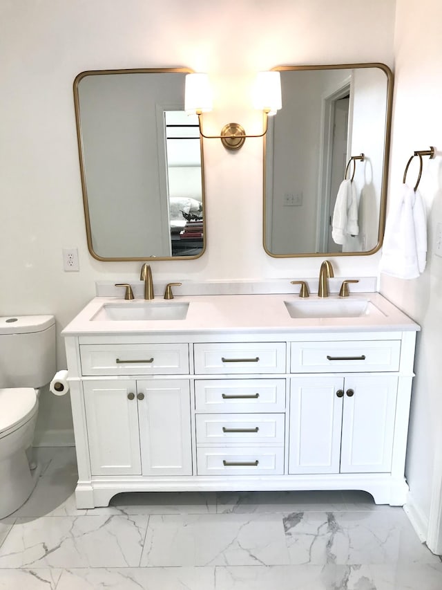 bathroom featuring vanity and toilet