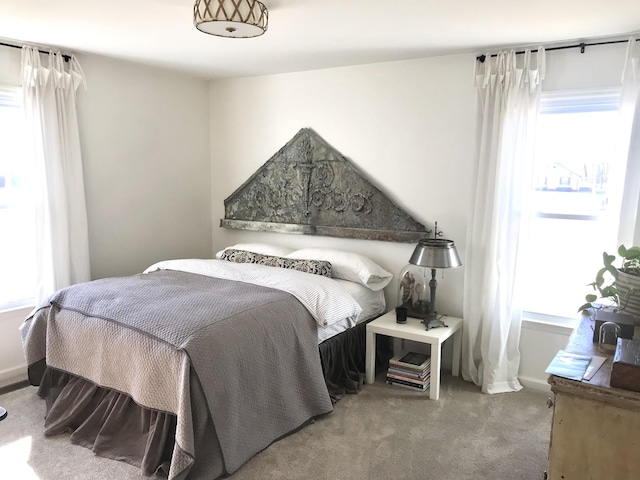 bedroom featuring multiple windows and carpet flooring