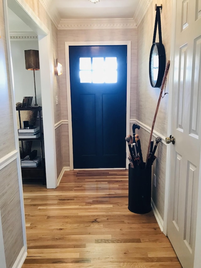 entrance foyer with ornamental molding and light wood-type flooring