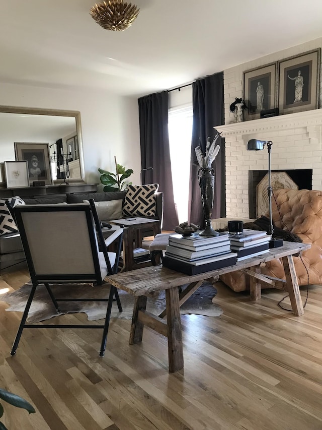 living area featuring hardwood / wood-style flooring and a fireplace