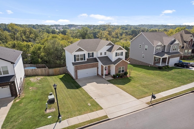 view of front of property featuring a garage and a front lawn